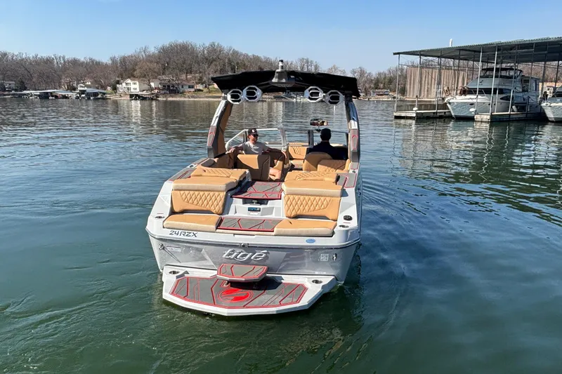 Slide: The Image of 2026 Tigé 24RZX boat on calm lake, featuring luxurious seating and modern design. - 69