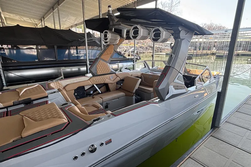 Slide: The Image of 2026 Tigé 24RZX boat with luxurious seating and modern design docked in a marina. - 7