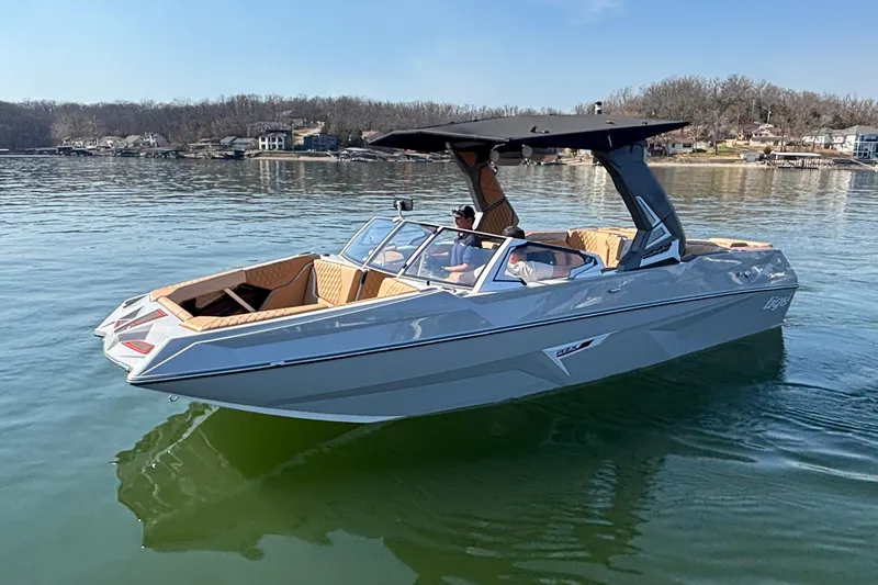 Slide: The Image of 2026 Tigé 24RZX boat on a calm lake, featuring sleek design and modern amenities. - 70