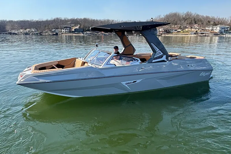 Slide: The Image of 2026 Tigé 24RZX boat on calm lake, featuring sleek design and modern amenities. - 71