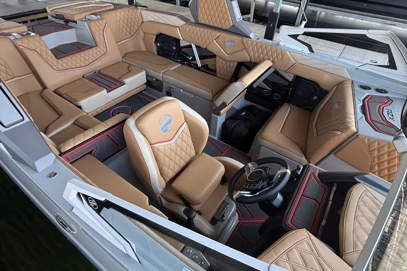 Slide: The Image of Luxurious interior of 2026 Tigé 24RZX boat with tan leather seating and modern dashboard. - 9