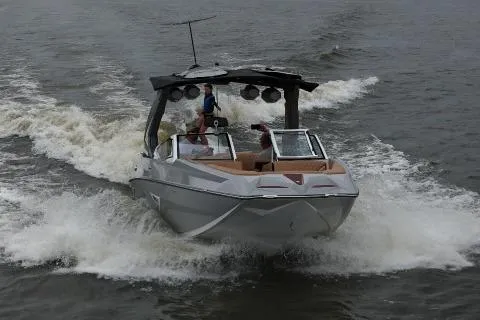 Slide: The Image of 2026 Tigé 24RZX boat cruising on water, creating dynamic waves. - 1
