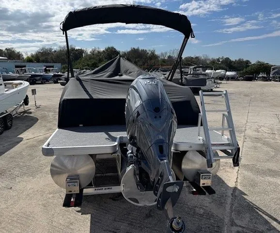 Slide: The Image of Sweetwater Xperience 2026 pontoon boat with motor and cover outdoors. - 13