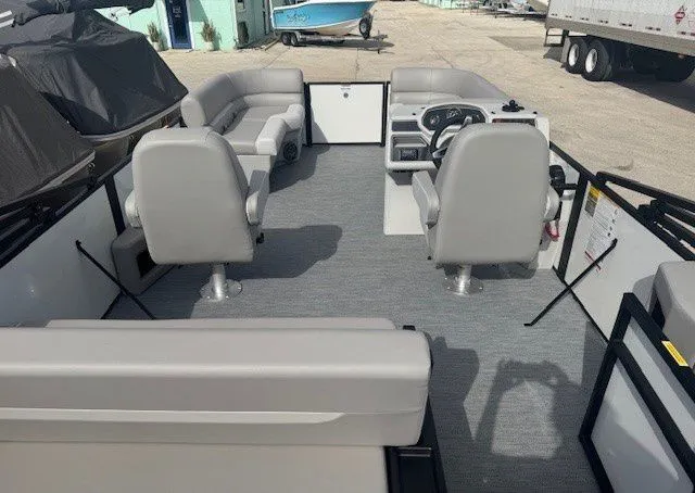 Slide: The Image of Interior of Sweetwater Xperience 2026 pontoon boat with gray seating. - 16