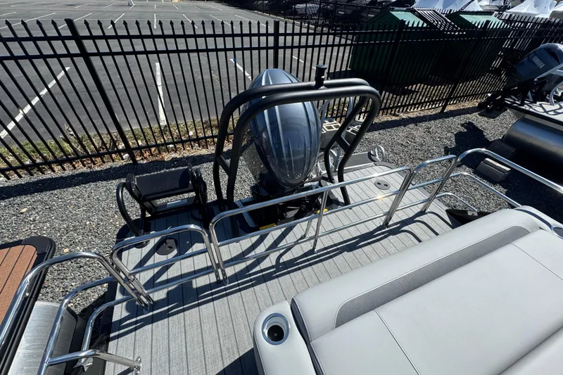 Slide: The Image of 2026 Bentley Pontoons Legacy 243 Swingback with sleek deck and powerful outboard motor. - 10