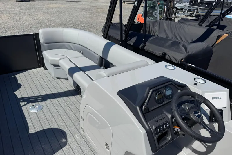 Slide: The Image of 2026 Bentley Pontoons Legacy 243 Swingback interior with sleek seating and modern dashboard. - 19