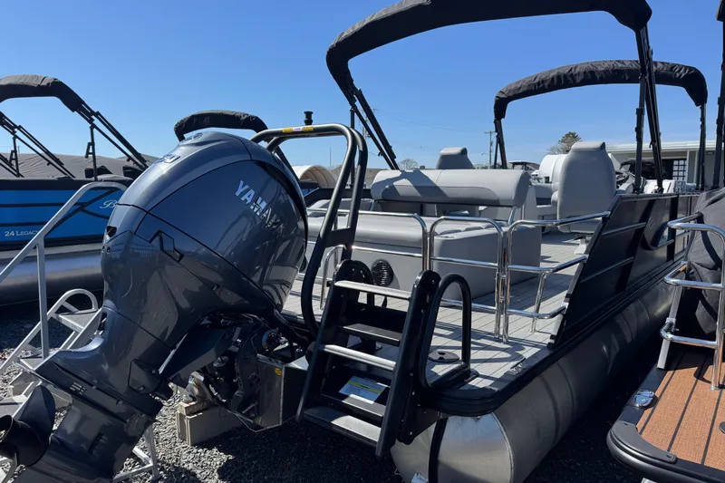 Slide: The Image of 2026 Bentley Pontoons Legacy 243 Swingback with Yamaha outboard motor, docked under clear sky. - 9