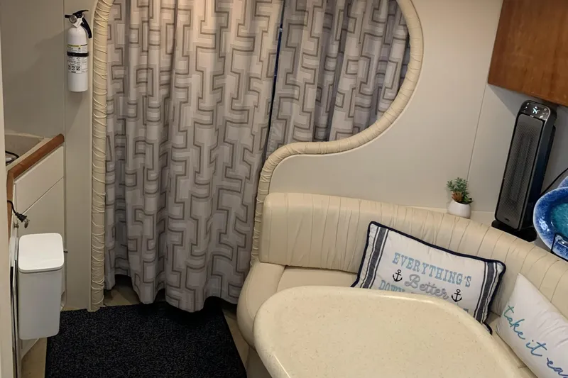 Slide: The Image of Interior of a 1998 Silverton 361 Express yacht with cozy seating and nautical decor. - 15