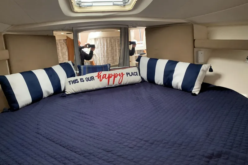 Slide: The Image of Cozy cabin interior of 1998 Silverton 361 Express with nautical-themed pillows. - 17