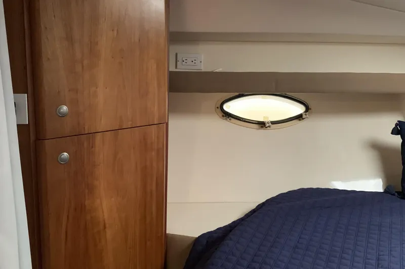 Slide: The Image of Interior cabin of 1998 Silverton 361 Express with wooden cabinet and porthole window. - 18