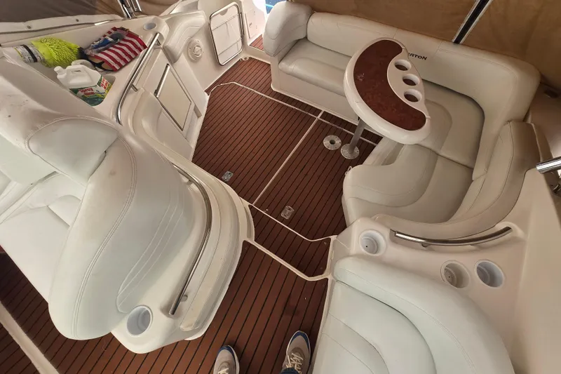 Slide: The Image of 1998 Silverton 361 Express yacht interior with white seating and wooden flooring. - 2