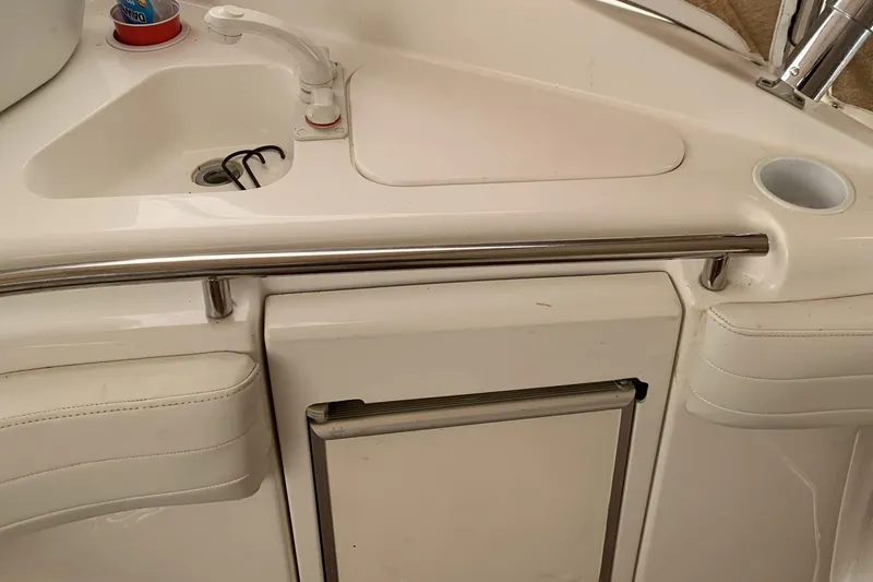 Slide: The Image of 1998 Silverton 361 Express boat kitchenette with sink and storage. - 24