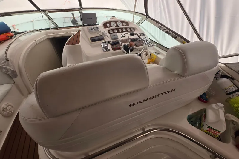 Slide: The Image of Interior of a 1998 Silverton 361 Express yacht cockpit with steering wheel and controls. - 6
