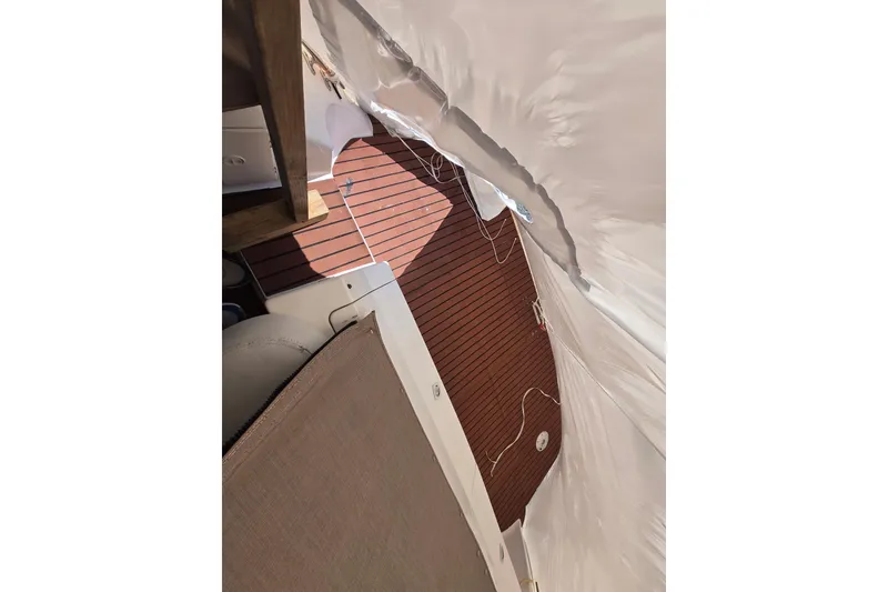 Slide: The Image of 1998 Silverton 361 Express boat interior with wooden flooring and protective covering. - 9