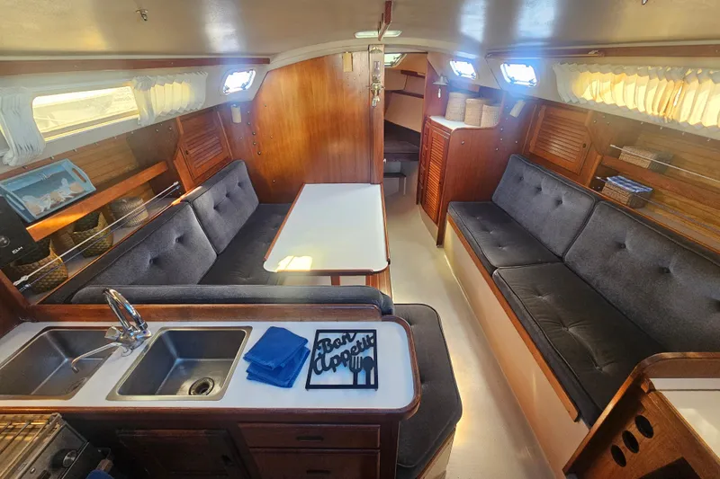 Slide: The Image of Interior of a 1988 Catalina 30 MkII sailboat with cozy seating and dining area. - 11