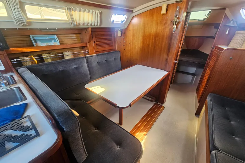 Slide: The Image of Interior of a 1988 Catalina 30 MkII sailboat with cozy seating and wooden finishes. - 12