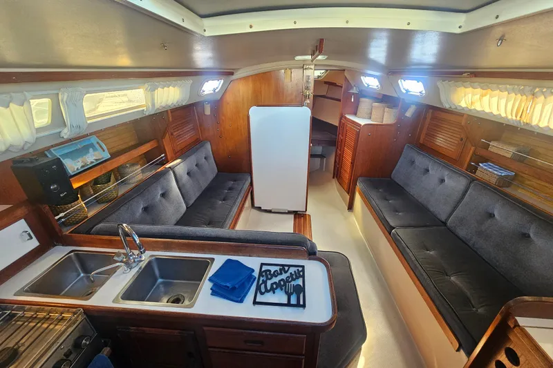 Slide: The Image of Interior of a 1988 Catalina 30 MkII sailboat with cozy seating and kitchenette. - 14