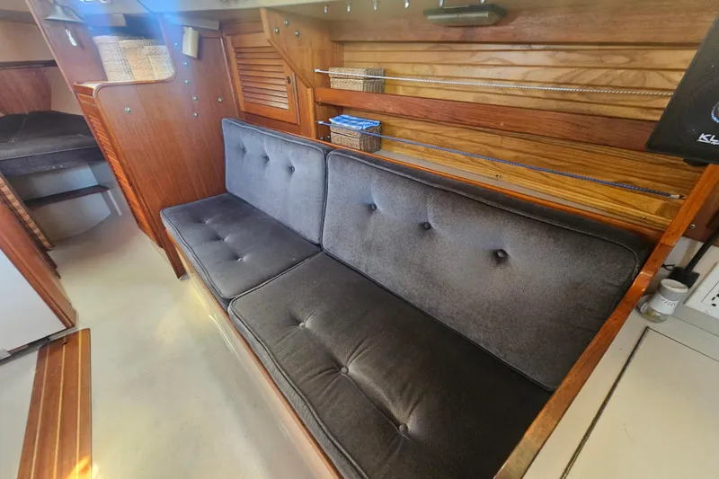 Slide: The Image of Interior of 1988 Catalina 30 MkII sailboat with cushioned seating and wooden accents. - 19