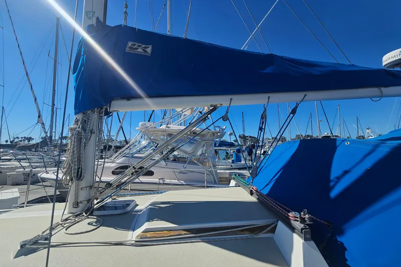 Slide: The Image of Sailboat Catalina 30 MkII 1988 with blue sail cover in marina under clear sky. - 2