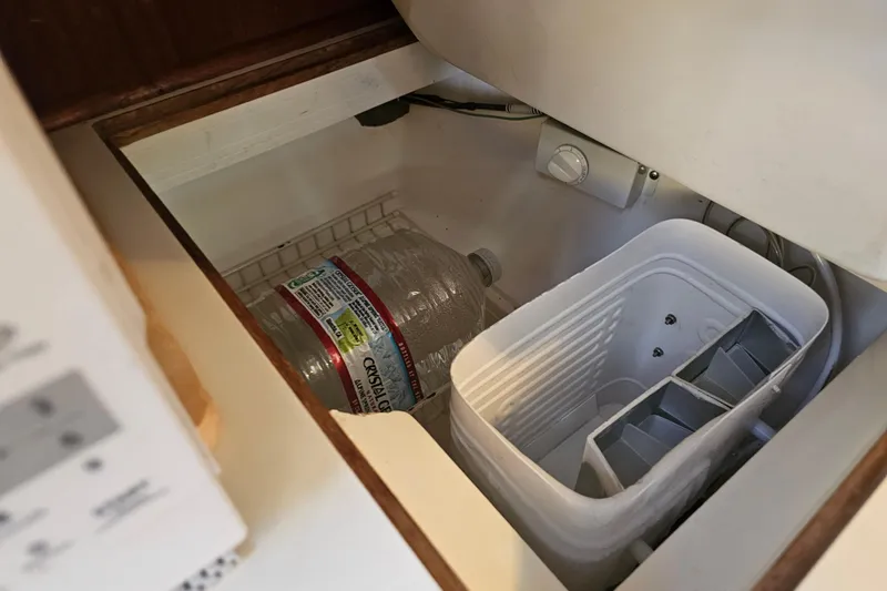 Slide: The Image of Icebox interior of 1988 Catalina 30 MkII sailboat with water bottle and ice tray. - 21