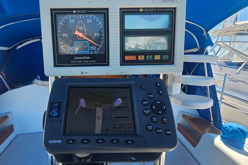 Slide: The Image of Cockpit instruments on a 1988 Catalina 30 MkII sailboat, featuring Garmin navigation and Signet wind speed displays. - 7