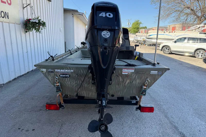 Slide: The Image of 2022 Tracker Grizzly 1648 SC boat with Mercury 40 engine, parked outdoors. - 10