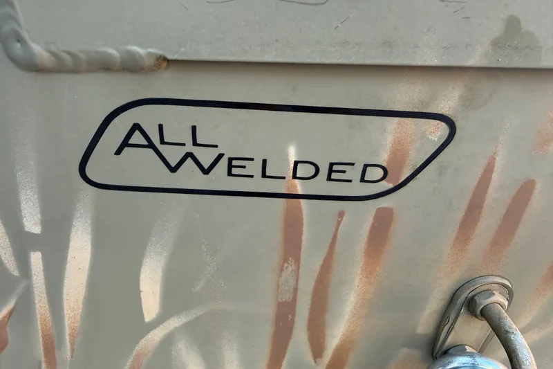 Slide: The Image of "All Welded" label on 2022 Tracker Grizzly 1648 SC boat exterior. - 11