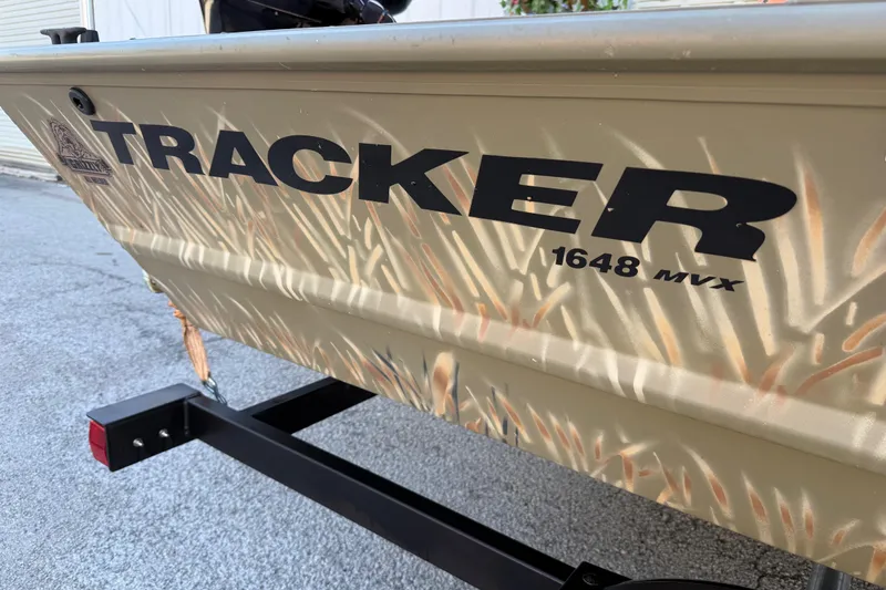Slide: The Image of 2022 Tracker Grizzly 1648 SC boat with camouflage design on a trailer. - 13