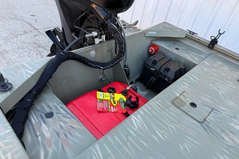 Slide: The Image of 2022 Tracker Grizzly 1648 SC boat interior with battery and motor components. - 15