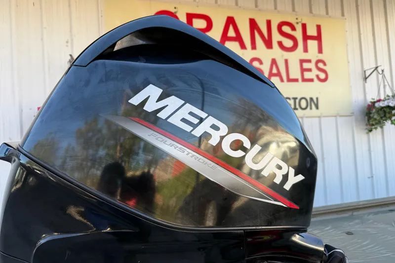 Slide: The Image of Mercury FourStroke engine on 2022 Tracker Grizzly 1648 SC boat at dealership. - 16
