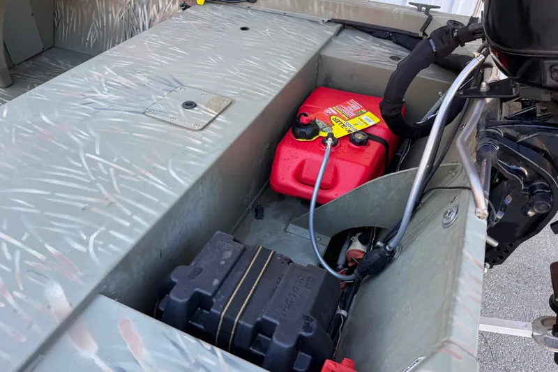 Slide: The Image of 2022 Tracker Grizzly 1648 SC boat interior with fuel tank and battery compartment. - 30