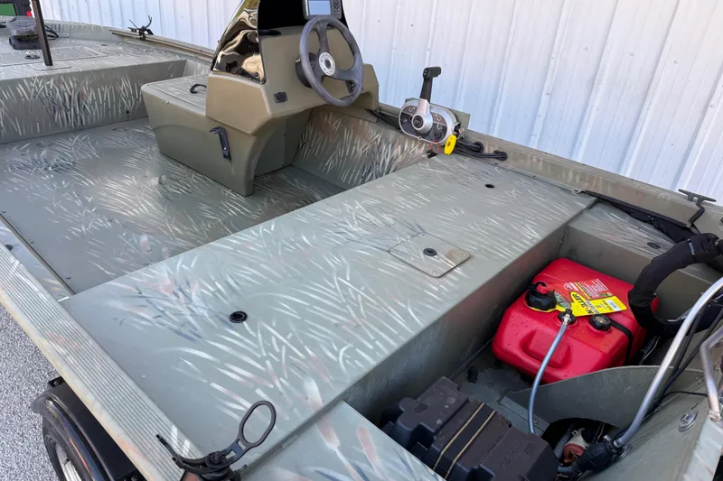 Slide: The Image of 2022 Tracker Grizzly 1648 SC boat interior with steering console and fuel tank. - 31