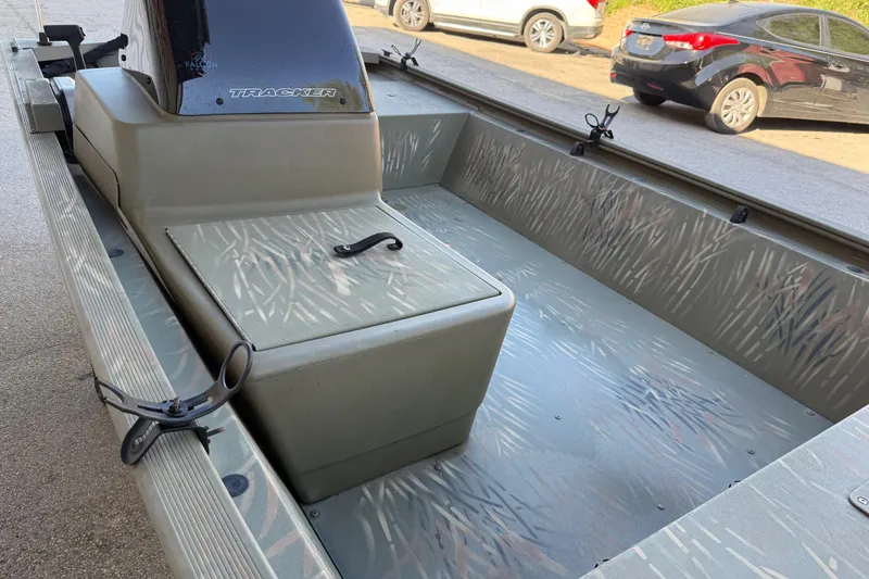 Slide: The Image of 2022 Tracker Grizzly 1648 SC boat interior with camouflage pattern and storage compartment. - 36