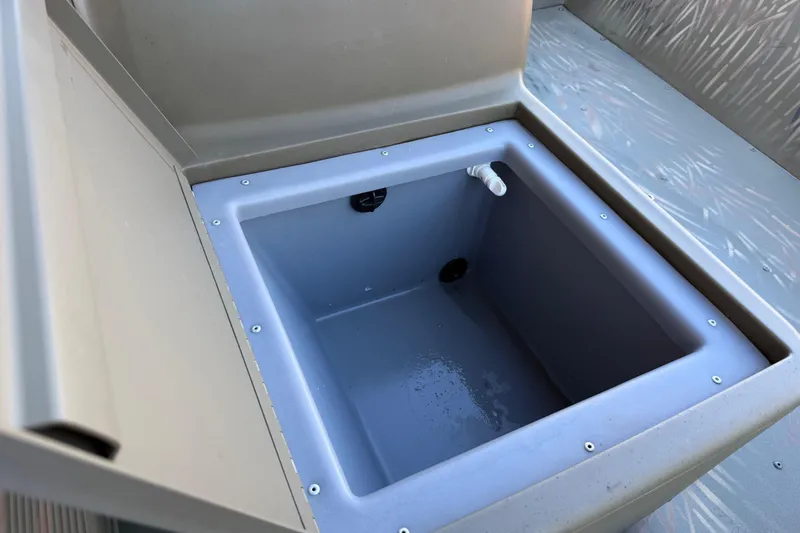 Slide: The Image of 2022 Tracker Grizzly 1648 SC boat storage compartment, open and empty. - 37