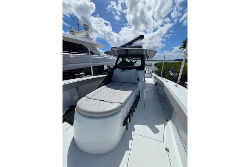 Slide: The Image of 2025 Freeman 47 boat with sleek design, spacious deck, and luxurious seating under a blue sky. - 10