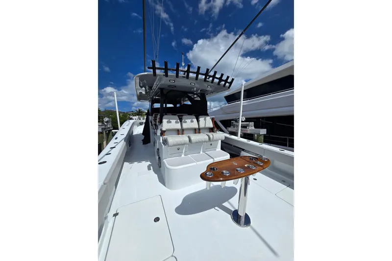 Slide: The Image of 2025 Freeman 47 yacht with sleek design, spacious deck, and modern seating under a clear blue sky. - 11