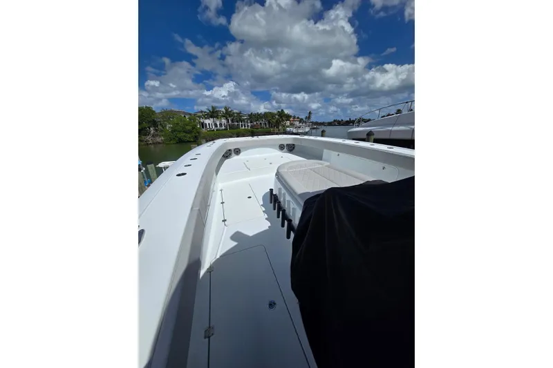 Slide: The Image of 2025 Freeman 47 boat deck with seating, under a partly cloudy sky. - 13