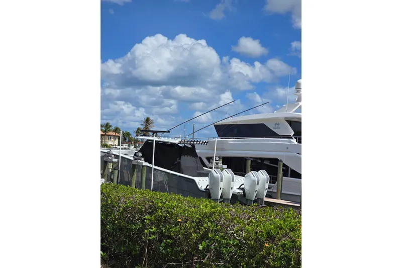 Slide: The Image of 2025 Freeman 47 boat docked under a vibrant blue sky with fluffy clouds. - 16