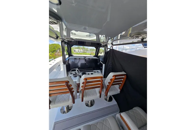 Slide: The Image of Interior view of 2025 Freeman 47 boat with luxurious seating and modern helm. - 5