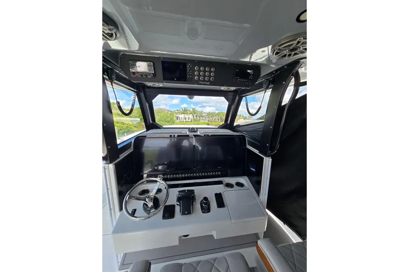 Slide: The Image of Interior view of a 2025 Freeman 47 boat cockpit with modern controls and steering wheel. - 6