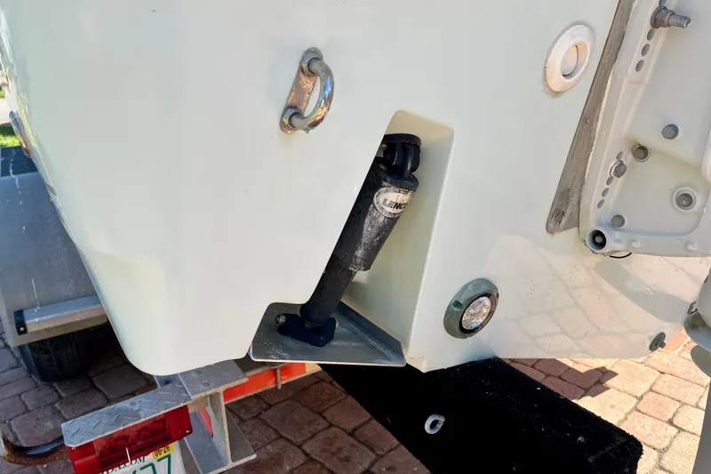 Slide: The Image of 2018 Pro-Line 26 Express boat stern detail with trailer, showing trim tab and fittings. - 11