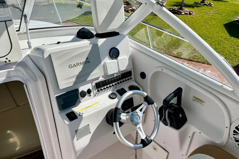 Slide: The Image of Cockpit of 2018 Pro-Line 26 Express boat with Garmin navigation system and steering wheel. - 14