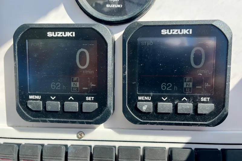 Slide: The Image of Suzuki digital displays on 2018 Pro-Line 26 Express boat dashboard, showing 62 hours. - 19