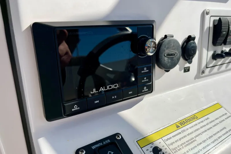 Slide: The Image of Control panel of 2018 Pro-Line 26 Express boat featuring JL Audio system. - 20