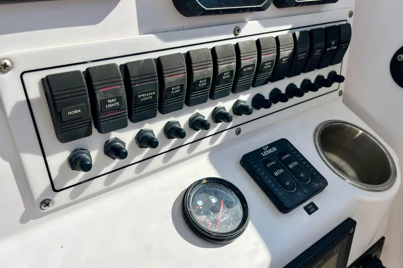 Slide: The Image of Control panel of a 2018 Pro-Line 26 Express boat with switches and gauges. - 21