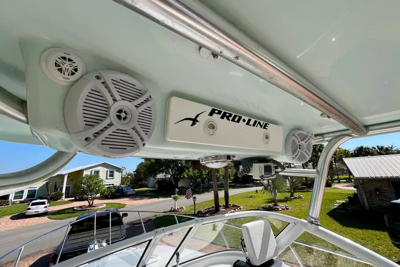 Slide: The Image of 2018 Pro-Line 26 Express boat with speakers and Pro-Line branding on the canopy. - 25