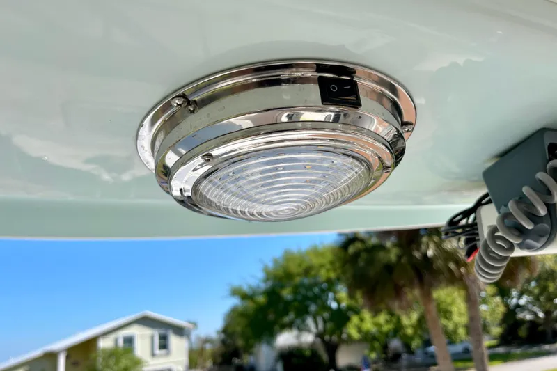 Slide: The Image of 2018 Pro-Line 26 Express boat light fixture, chrome finish, outdoor setting. - 27