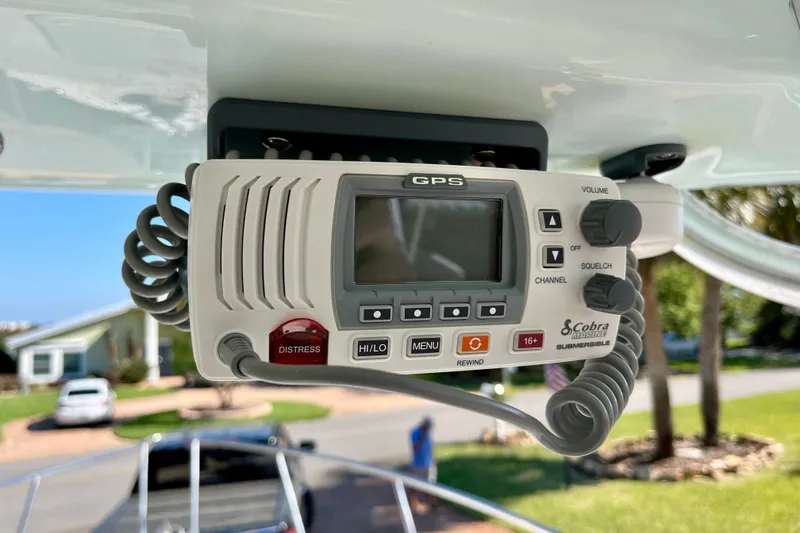 Slide: The Image of Cobra Marine GPS radio on 2018 Pro-Line 26 Express boat, featuring distress button. - 28