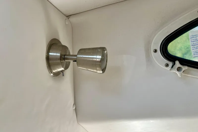 Slide: The Image of Interior light fixture and window in 2018 Pro-Line 26 Express boat cabin. - 31