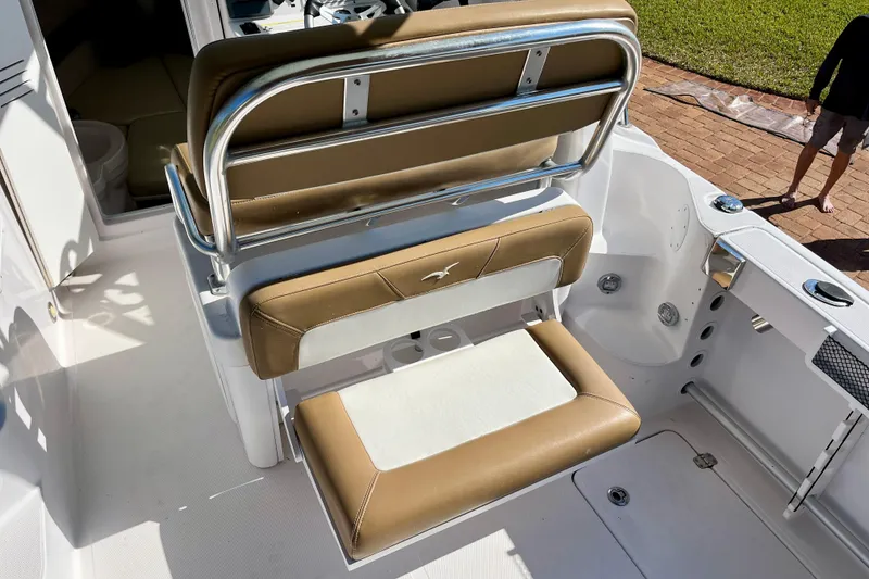 Slide: The Image of 2018 Pro-Line 26 Express boat interior with tan seating and stainless steel accents. - 36
